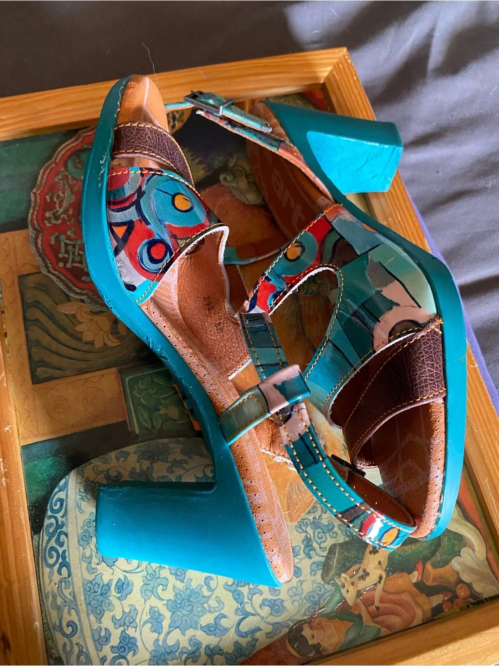 The Art Company, featuring a turquoise and multi-colored abstract pattern